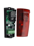 A red gate safety sensor with its black plastic housing and internal green circuit board visible, shown next to the red translucent cover on a white background.